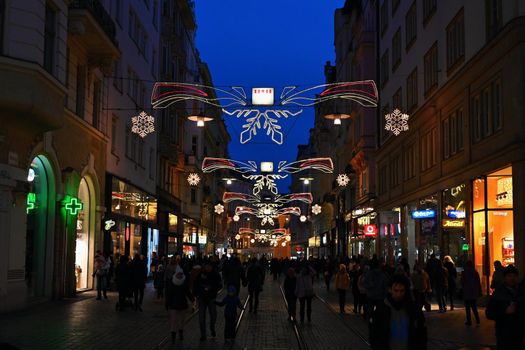 1 December 2019 Brno. Christmas holidays in the center of Brno. Street with shops and Christmas decor with people