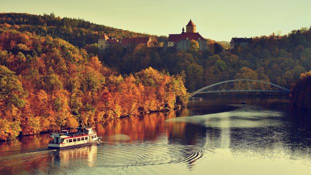 Beautiful Autumn Landscape with Veveri Castle. Natural colorful scenery with sunset. Brno dam-Czech Republic-Europe.