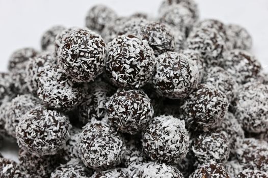Rum balls in coconut. Classic Czech Christmas cookies. Hand made unbaked sweets with alcohol.