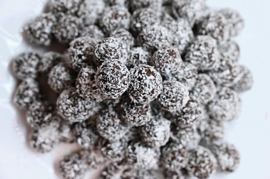 Rum balls in coconut. Classic Czech Christmas cookies. Hand made unbaked sweets with alcohol.