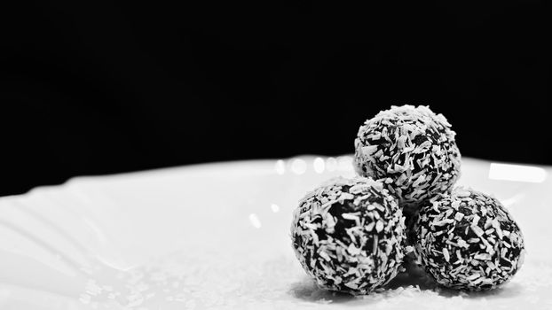 Rum balls in coconut. Classic Czech Christmas cookies. Hand made unbaked sweets with alcohol.