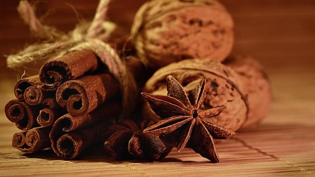 Cinnamon and star anise on a wooden background. Beautiful and fragrant spices for Christmas time and winter cooking season.