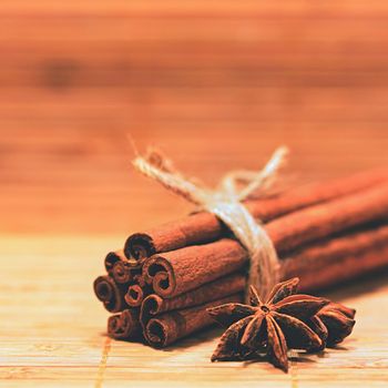 Cinnamon and star anise on a wooden background. Beautiful and fragrant spices for Christmas time and winter cooking season.