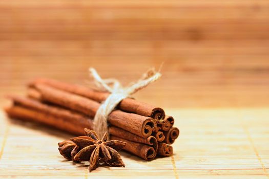 Cinnamon and star anise on a wooden background. Beautiful and fragrant spices for Christmas time and winter cooking season.