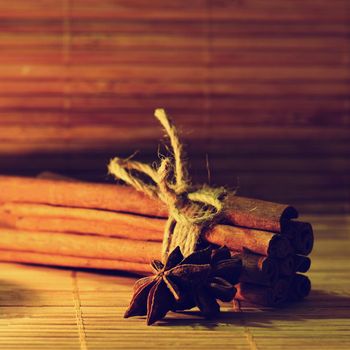 Cinnamon and star anise on a wooden background. Beautiful and fragrant spices for Christmas time and winter cooking season.