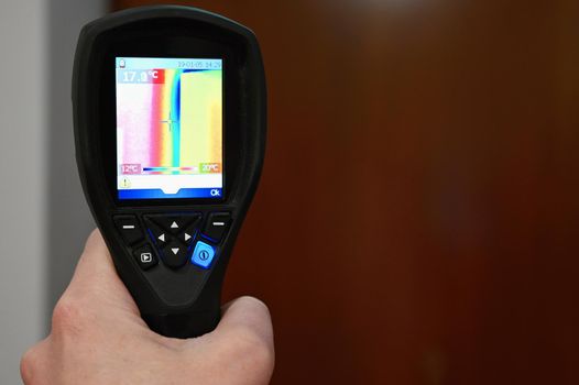 Hand thermal imaging camera to check temperature .