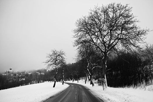 Road in winter. Snowy mountain path for a car. Concept for traveling and safe driving in winter by car.