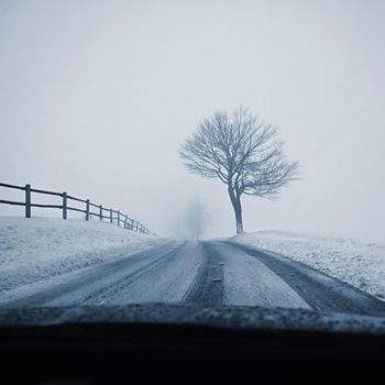 Driving the car in the winter. View from the interior of a car on a snowy road by the eyes of the driver. Concept for driving safety in the winter.