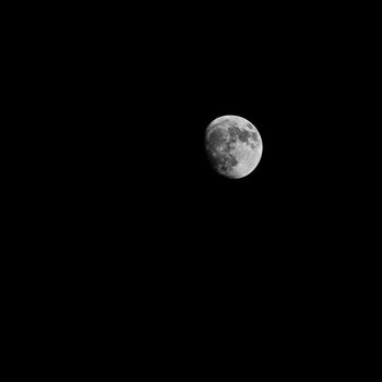 Full moon over dark black sky at night