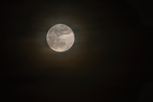 Full moon over dark black sky at night