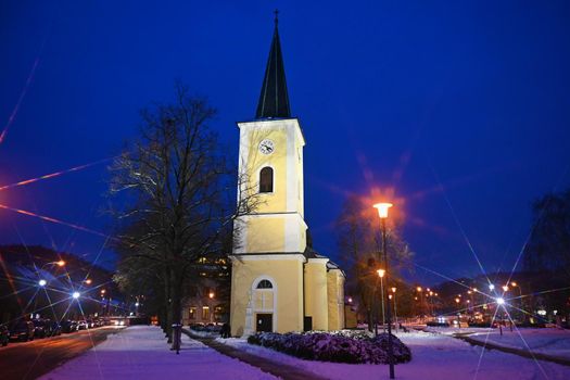 Beautiful old church on Christmas holidays with snow and stars.