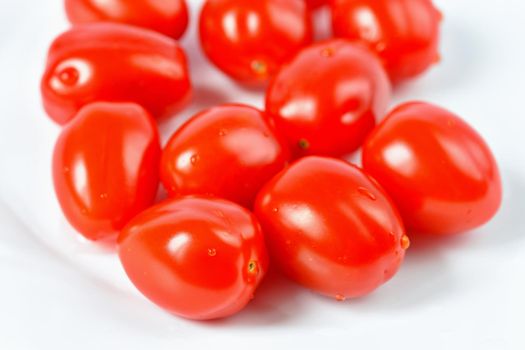 Cherry tomatoes stack isolated on white background