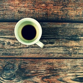 Blank and dirty white coffee mug on a wooden background.