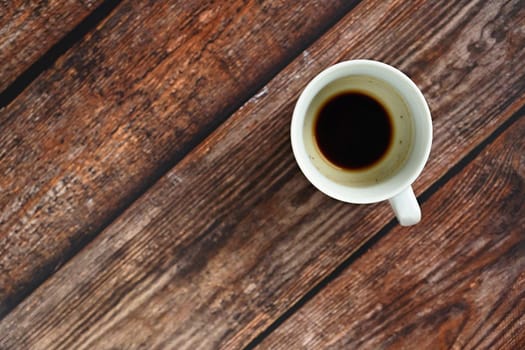 Blank and dirty white coffee mug on a wooden background.