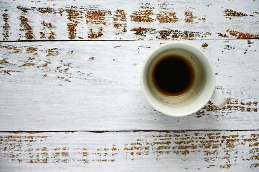 Blank and dirty white coffee mug on a wooden background.