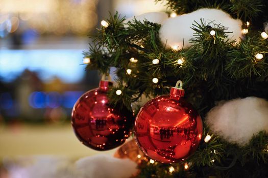 Colorful christmas Decoration. Winter holidays and traditional ornaments on a Christmas tree. Lighting chains - candles for seasonal background.