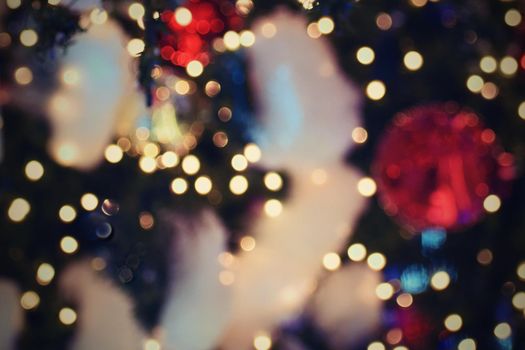 Colorful christmas Decoration. Winter holidays and traditional ornaments on a Christmas tree. Lighting chains - candles for seasonal background.