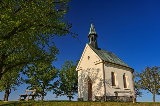 Beautiful little church with trees and blue sky. Brno-Lisen - Czech Republic. Chapel of Our Lady Help of Christians
