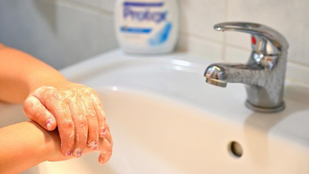 Thorough hand washing with disinfectant soap. Quarantine - domestic hygiene. Measures against coronavirus disease. (COVID-19)