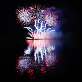 Beautiful colorful fireworks with reflections in water. Brno dam, the city of Brno-Europe. International Fireworks Competition.