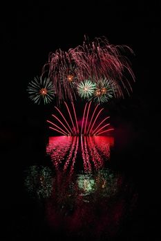 Beautiful colorful fireworks with reflections in water. Brno dam, the city of Brno-Europe. International Fireworks Competition.