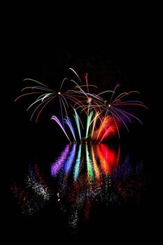 Beautiful colorful fireworks with reflections in water. Brno dam, the city of Brno-Europe. International Fireworks Competition.