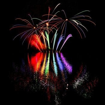 Beautiful colorful fireworks with reflections in water. Brno dam, the city of Brno-Europe. International Fireworks Competition.