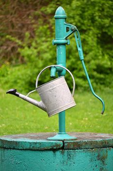 Classic hand pump for water - well with kettle for watering the garden.