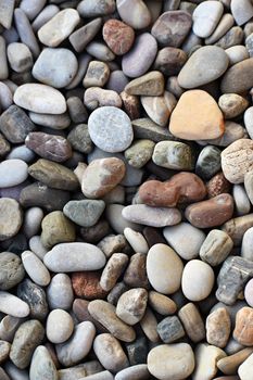 Beautiful colorful stones by the sea on the beach.