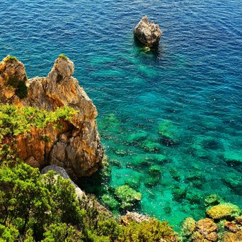 Beautiful beach and boats. Clean sea with a bay. Concept for travel, vacation and tourism. Great place for summer holidays and swimming. Paleokastritsa, Corfu island, Greece.