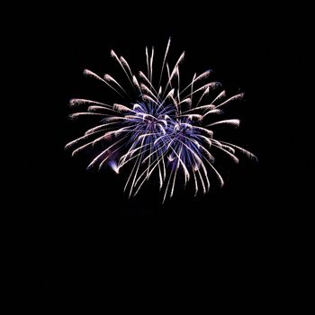 Beautiful colorful fireworks on the water surface. Night scene. Concept for holidays and celebrations.