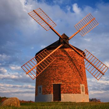Beautiful old windmill in autumn time. Landscape photo with architecture at sunset (golden hour). Chvalkovice - Czech Republic - Europe.