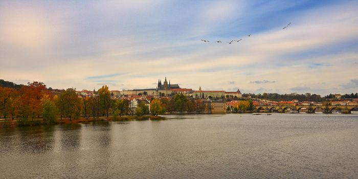 Prague, capital of the Czech Republic. Scenic sunset view of the Old Town pier architecture and Charles Bridge over Vltava river. 