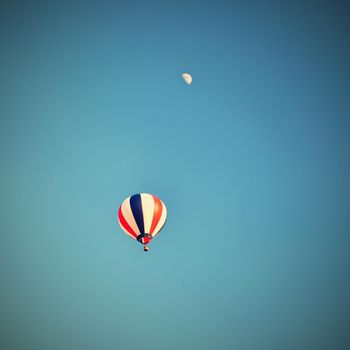 Colorful hot air balloon flying at sunset. Natural colorful background with sky.
