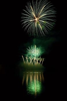 Beautiful colorful fireworks on the water surface with a clean black background. Fun festival and international contest of Firefighters from all over the world Ignis Brunensis 2017. Brno Dam - Czech Republic.