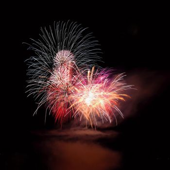 Beautiful colorful fireworks on the water surface with a clean black background. Fun festival and international contest of Firefighters from all over the world Ignis Brunensis 2017. Brno Dam - Czech Republic.