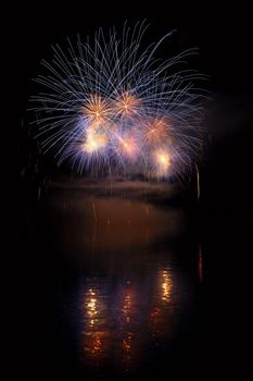 Beautiful colorful fireworks on the water surface with a clean black background. Fun festival and international contest of Firefighters from all over the world Ignis Brunensis 2017. Brno Dam - Czech Republic.