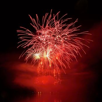 Beautiful colorful fireworks on the water surface with a clean black background. Fun festival and international contest of Firefighters from all over the world Ignis Brunensis 2017. Brno Dam - Czech Republic.