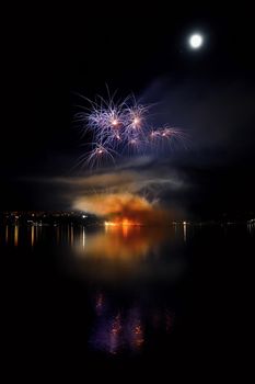 Beautiful colorful fireworks on the water surface with a clean black background. Fun festival and international contest of Firefighters from all over the world Ignis Brunensis 2017. Brno Dam - Czech Republic.