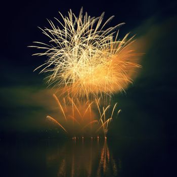 Beautiful colorful fireworks on the water surface with a clean black background. Fun festival and international contest of Firefighters from all over the world Ignis Brunensis 2017. Brno Dam - Czech Republic.