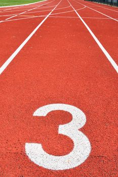 Running track with number 3. Colorful background for sport.