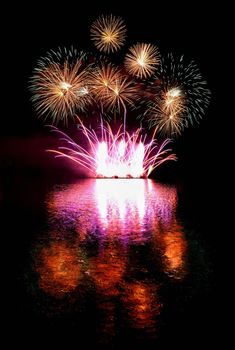 Firework. Beautiful colorful fireworks on the water surface with a clean black background. Fun festival and contest of Firefighters  Brno Dam - Czech Republic.