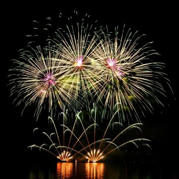 Firework. Beautiful colorful fireworks on the water surface with a clean black background. Fun festival and contest of Firefighters  Brno Dam - Czech Republic.