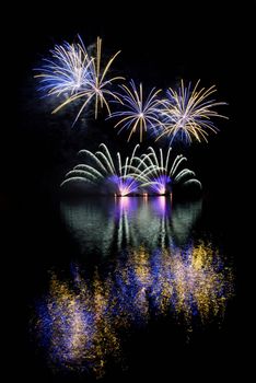 Firework. Beautiful colorful fireworks on the water surface with a clean black background. Fun festival and contest of Firefighters  Brno Dam - Czech Republic.