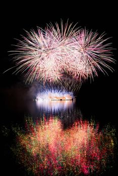 Firework. Beautiful colorful fireworks on the water surface with a clean black background. Fun festival and contest of Firefighters  Brno Dam - Czech Republic.