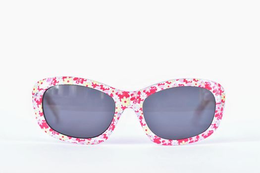 Sunglasses. Baby, pink-white colorful glasses isolated on a clean white background.