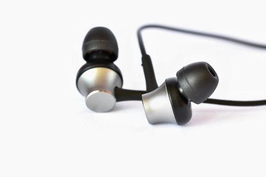 Headphones - small black balls. Isolated on a clean white background.