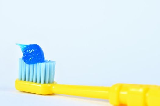 Toothbrush with paste on a white background.
