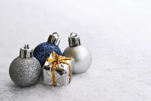 Christmas background. Beautiful decorations for the Christmas tree on real snow. Objects for the holidays and winter time.