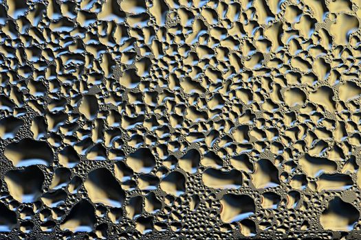 Colorful abstract background. Beautiful macro shot of water drops on a window.